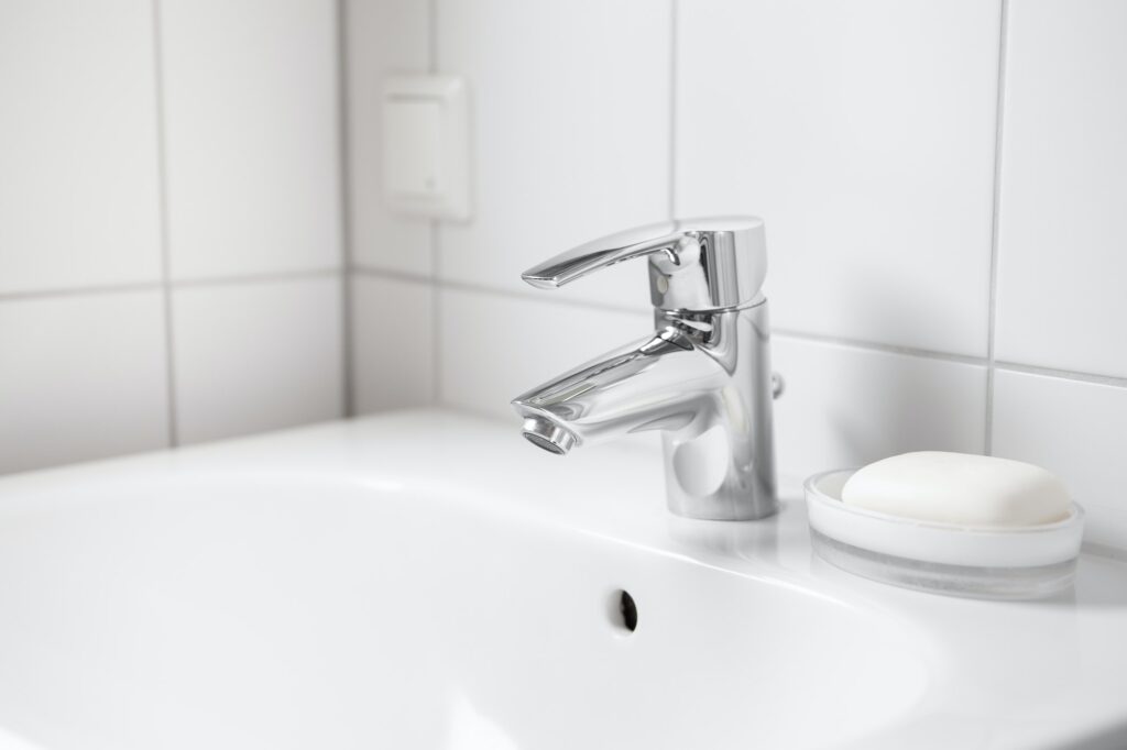 White ceramic sink with faucet and soap